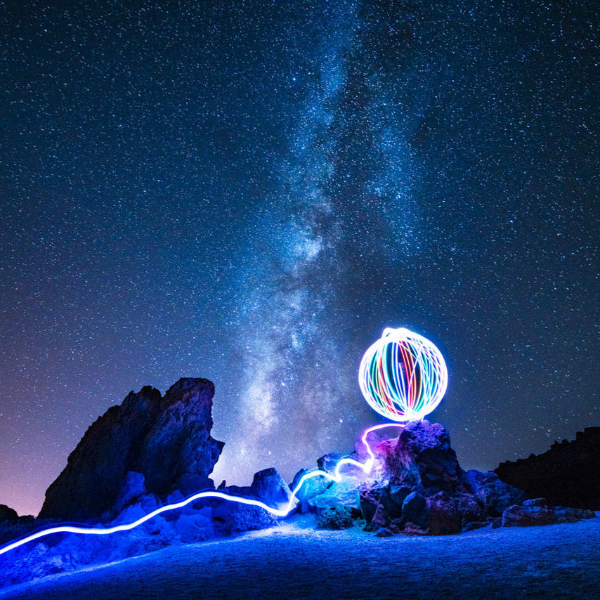 Nick Woolsey spinning flowtoys LED podpoi with beautiful long exposure trails against a starry night sky