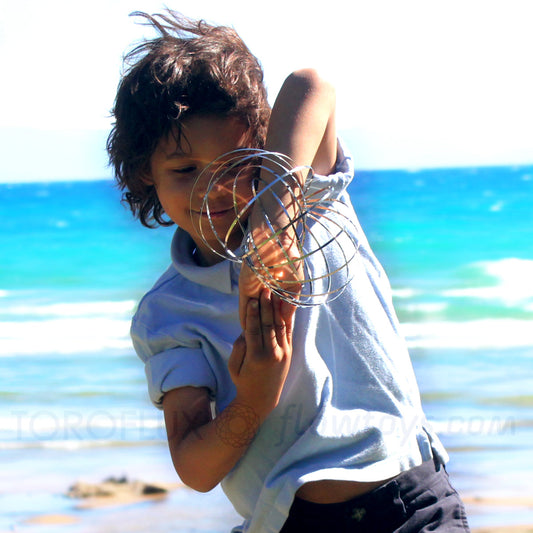 kid playing with the original toroflux kinetic spring toy, great toy for kids and adults alike