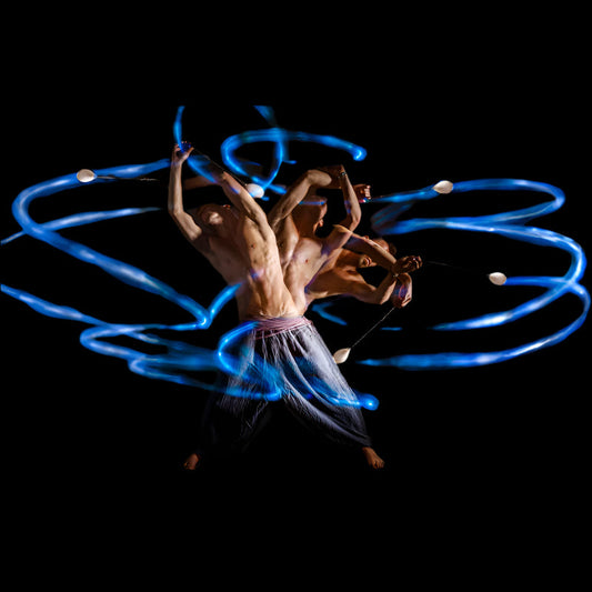 Rom Gai spinning flowtoys LED podpoi with long exposure and blue flash trails